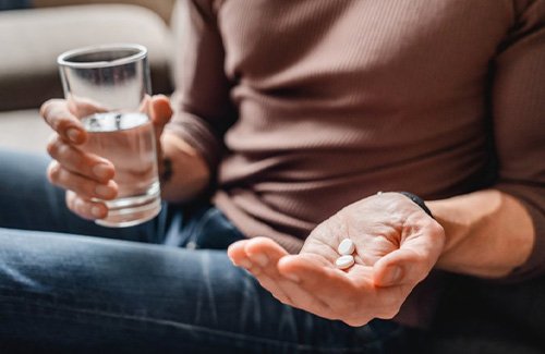 a person preparing to take pain medications