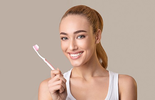 Woman holding a toothbrush